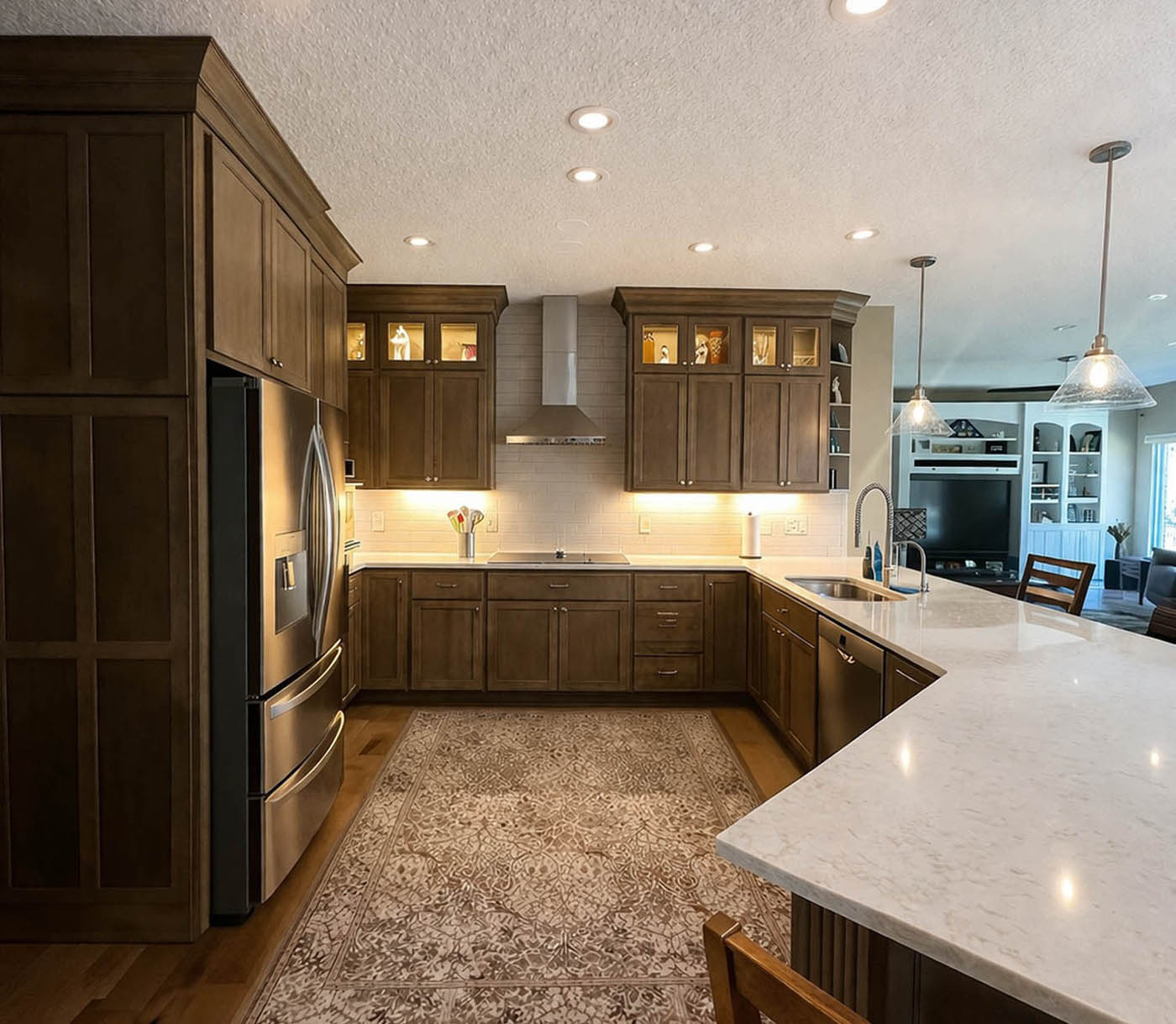 White modern kitchen remodel with quartz island and stainless steel appliances in Cincinnati